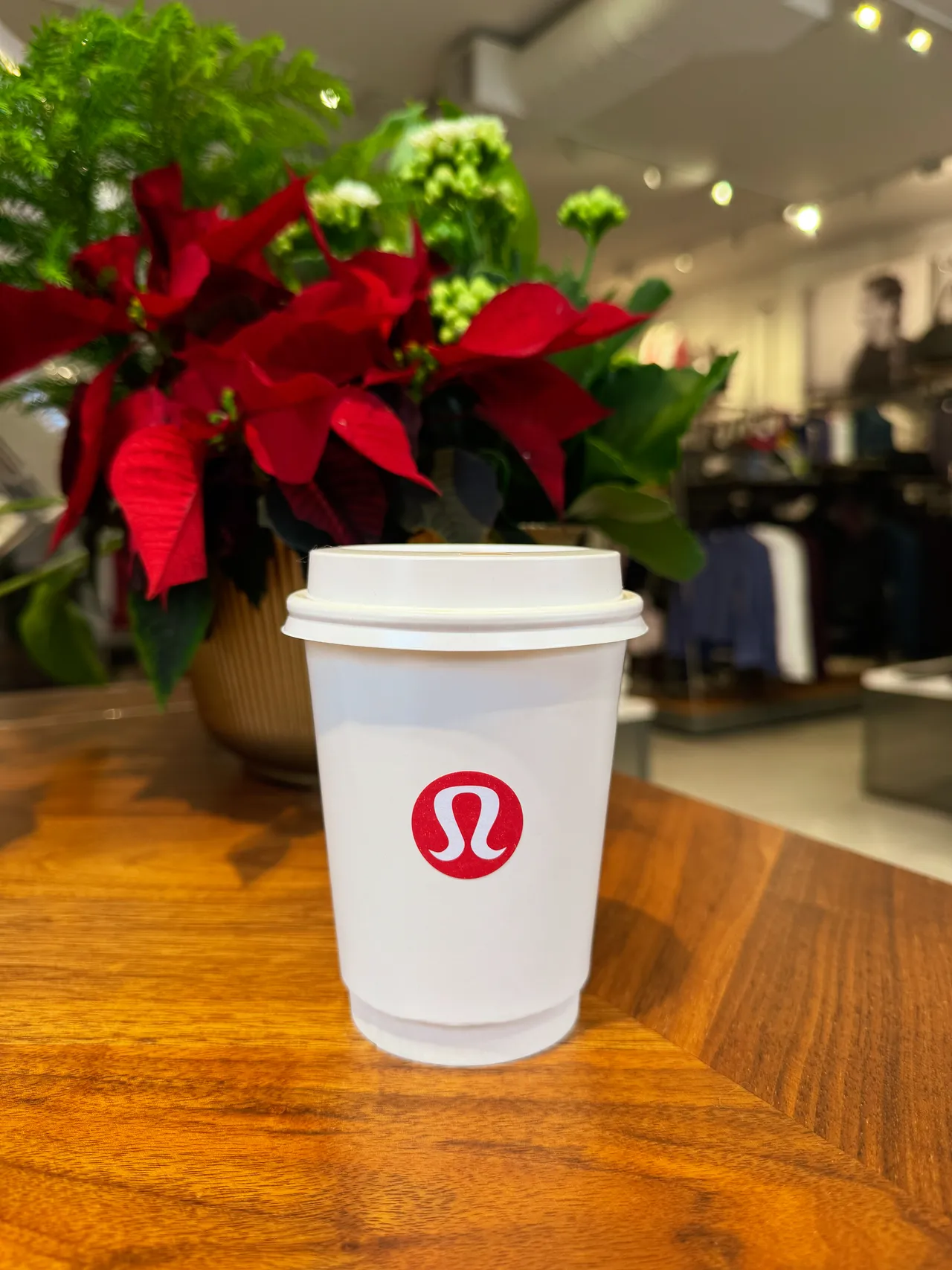 Coffee cup custom branded with the Lululemon logo