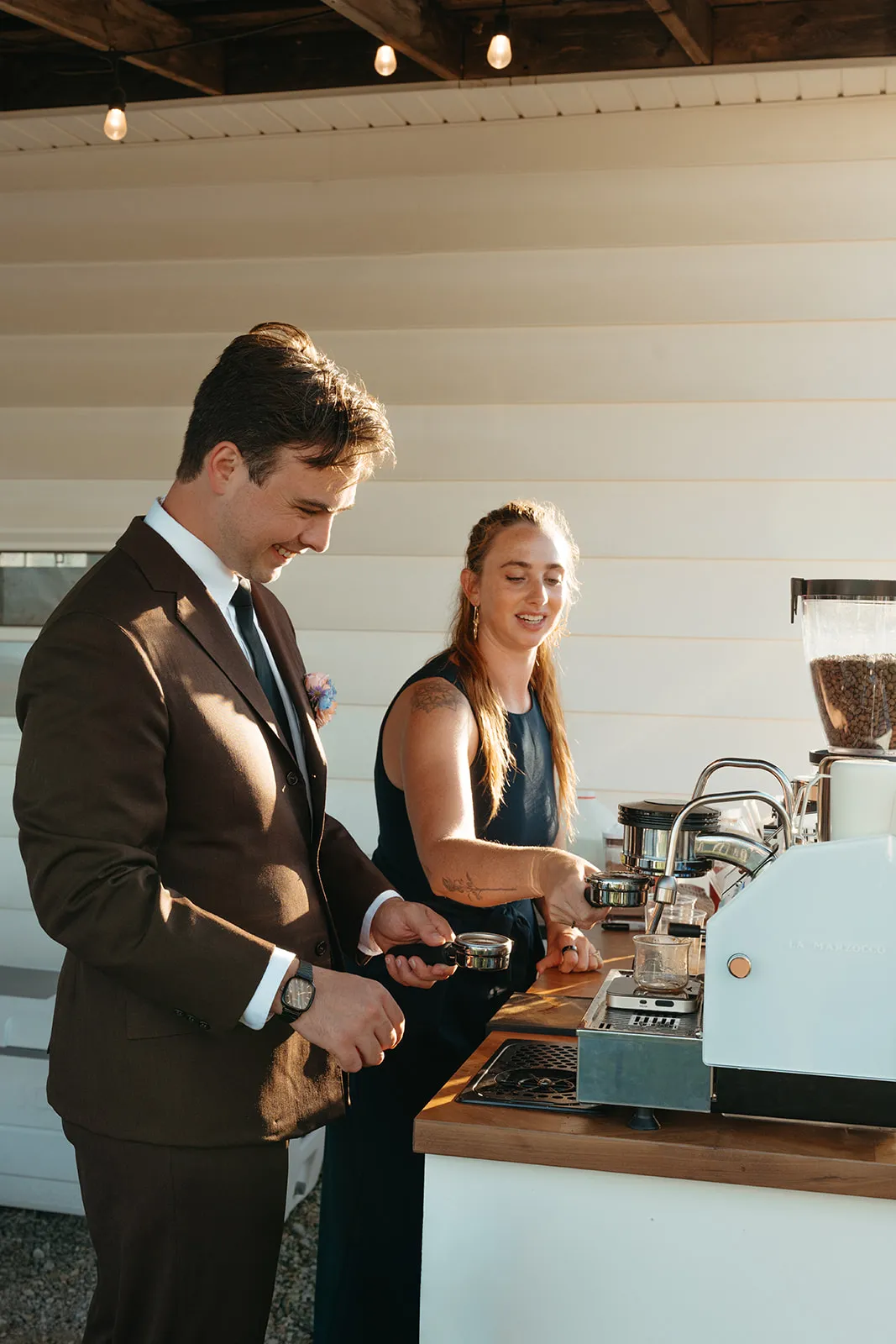 A Coffee Haus barista handing a freshly made drink to a guest at an event