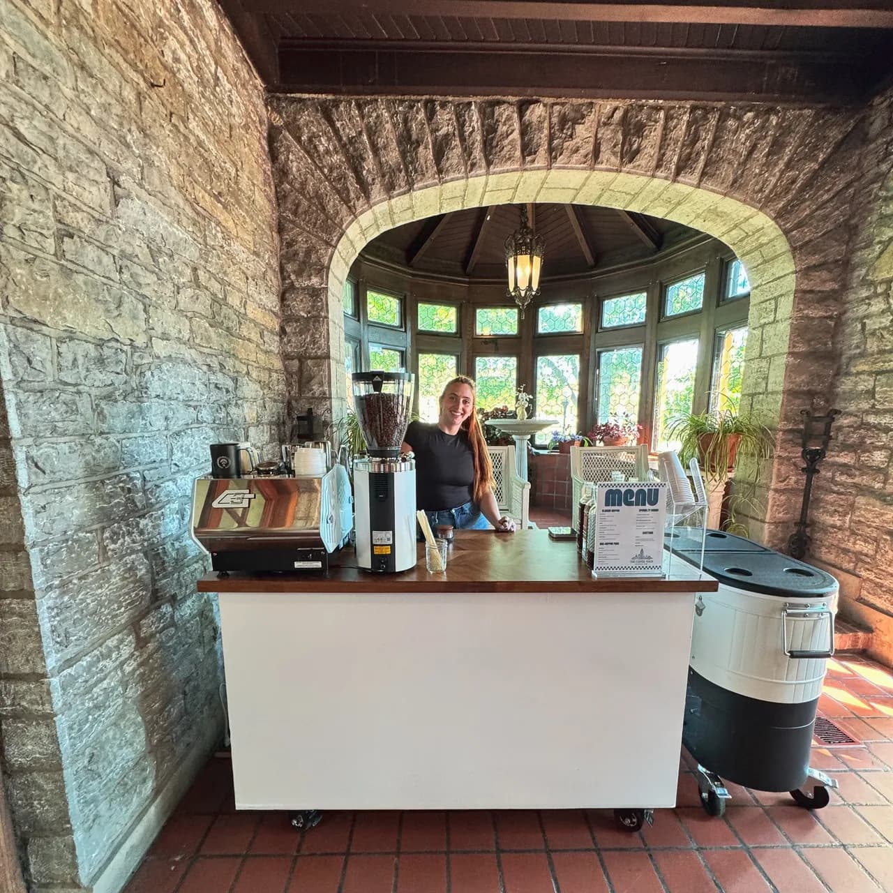Mobile coffee cart set up under a stone archway at a historic Cincinnati venue