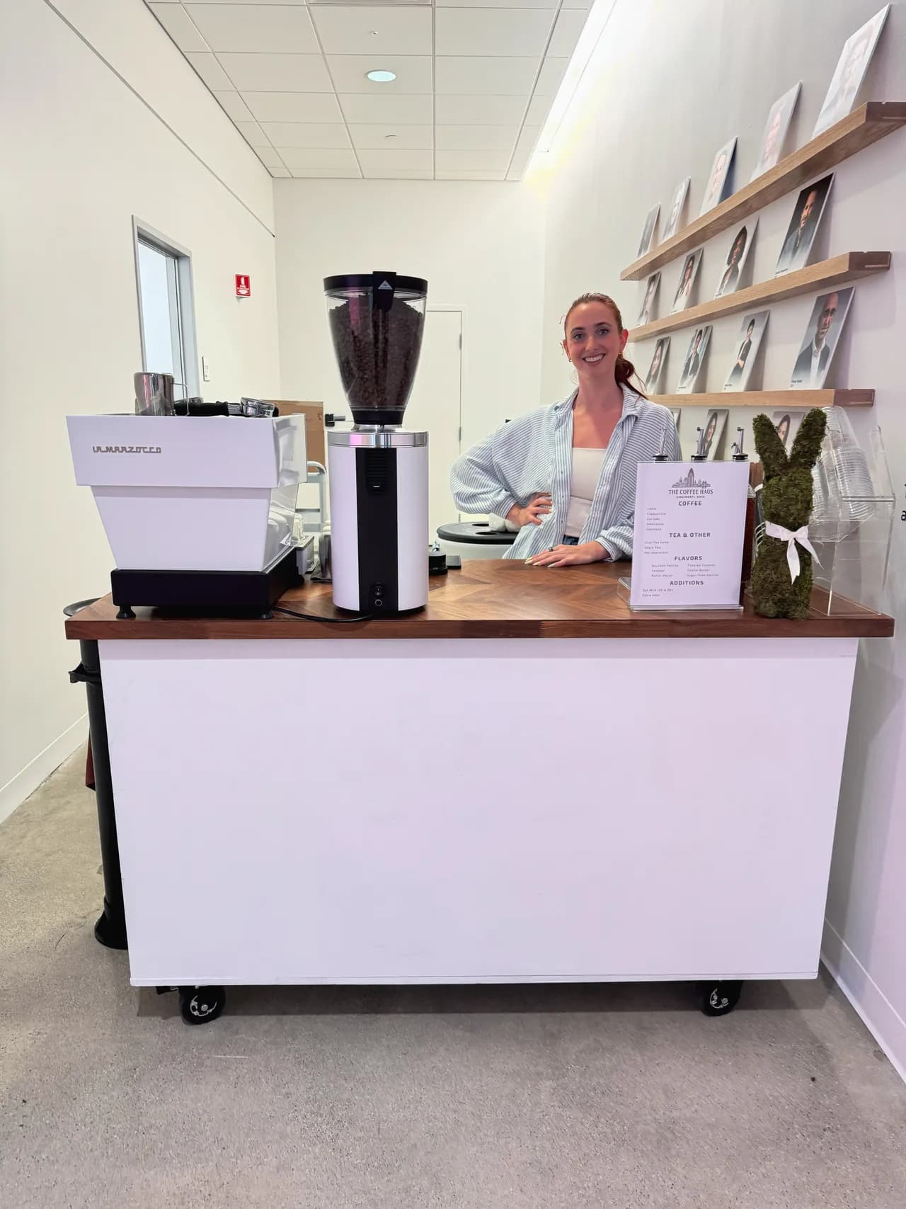 A Coffee Haus barista behind the mobile coffee cart ready to serve guests
