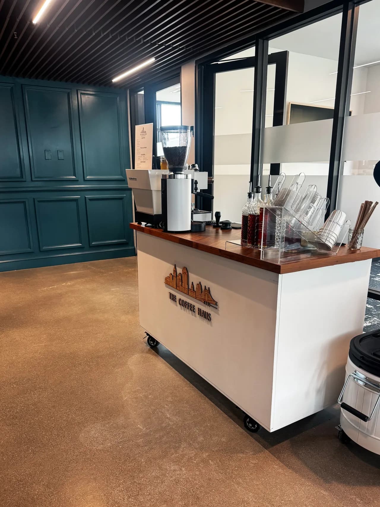 The Coffee Haus coffee cart with its skyline logo, set up inside an event venue